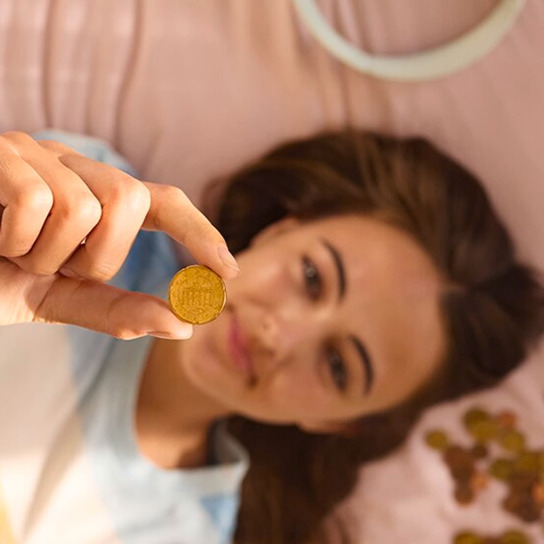 Moteris guli ant sofos ir laiko centą iškeltą į viršų